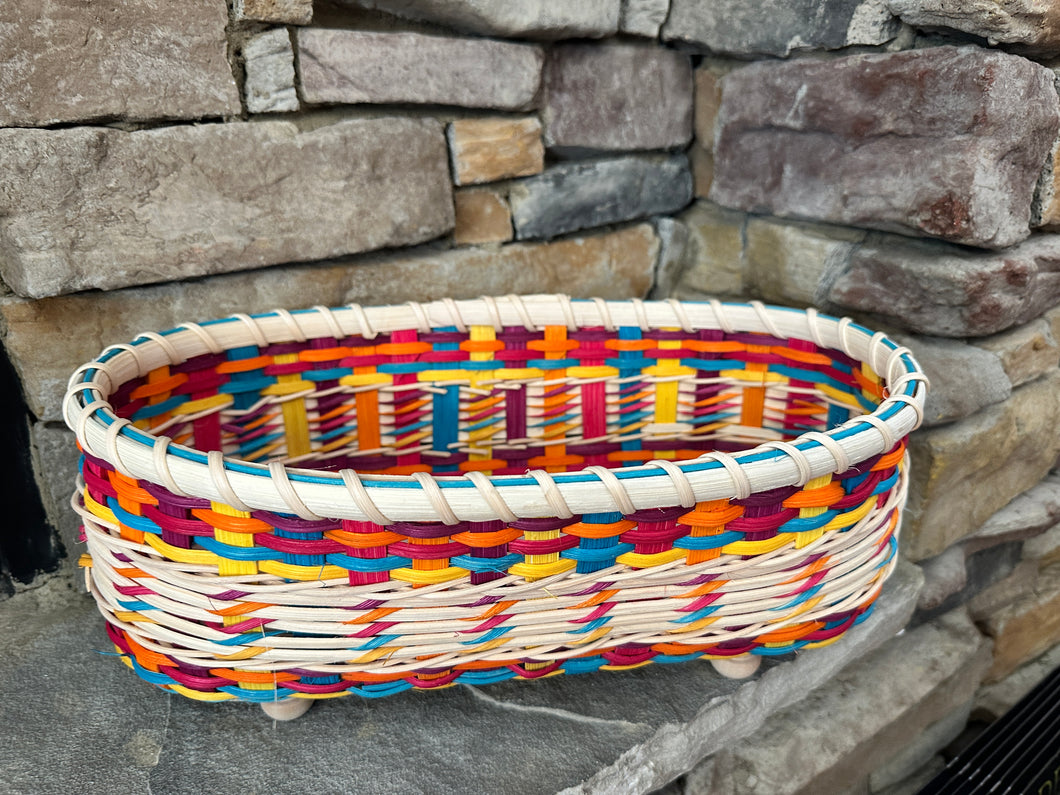 Multi-colored footed oval basket